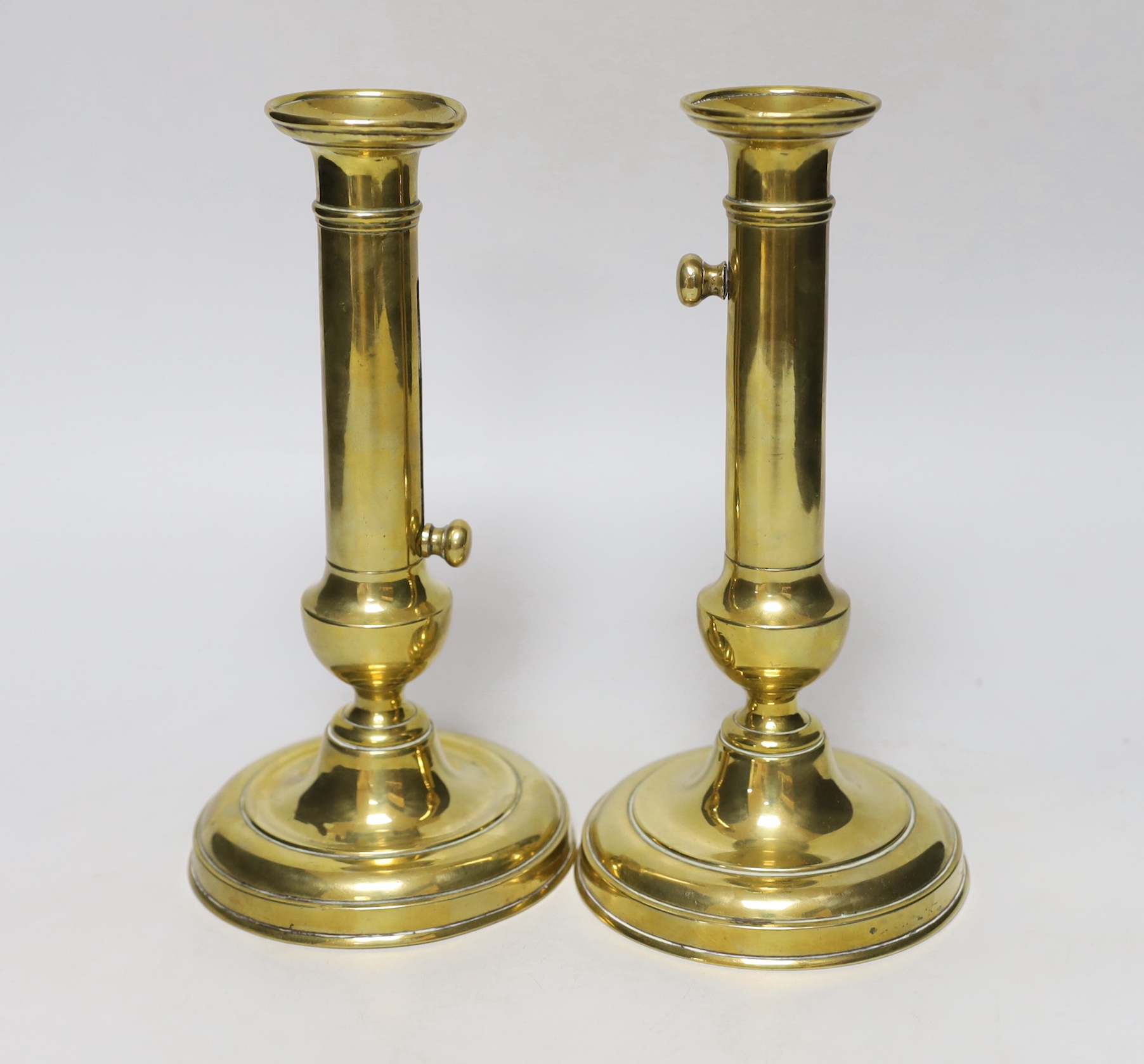 A pair of brass telescopic candlesticks, 23cm tall